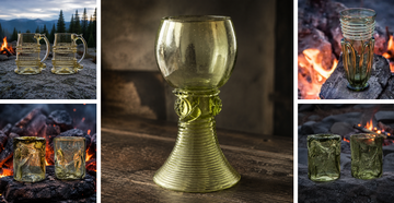 Collection of handmade green Waldglas goblets, beer mugs, feasting cups, and spirit glasses displayed beside campfires.